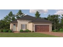 Inviting home featuring a two-car garage, manicured lawn, and neutral color palette at 11861 Sparkling Topaz Cv, Parrish, FL 34219