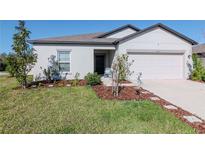 Charming home with a manicured lawn, fresh landscaping, and a welcoming front entrance at 12103 Gothic Rd, Spring Hill, FL 34610