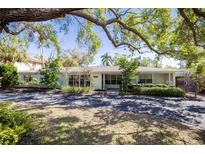 Charming single-story home featuring a well-maintained front yard and a wide driveway at 1433 Park N St, St Petersburg, FL 33710