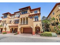 Charming multi-story townhome features a private garage, and an inviting front entrance at 254 Seagate Ct, Dunedin, FL 34698