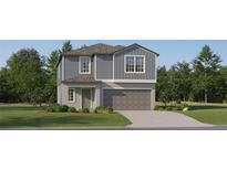 Two-story home featuring lap siding and board and batten accents, a two-car garage, and low-maintenance landscaping at 8440 Sea Ray Run, Parrish, FL 34219