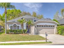 Charming single-story home with lush landscaping, two car garage and freshly cut lawn at 10641 Firebrick Ct, Trinity, FL 34655