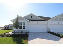Charming single Gathering home featuring a two car garage and a beautifully manicured lawn at 2832 Marrakesh Ln, Sarasota, FL 34234