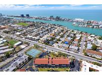 Breathtaking aerial view of a coastal community with lush landscaping and waterfront access to the tranquil bay at 8711 Blind Pass Rd # 207A, St Petersburg, FL 33706