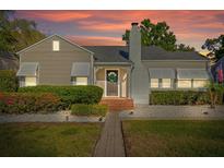 Charming single-Gathering home with a well-manicured lawn, brick walkway, and inviting entrance at 108 S Lincoln Ave, Tampa, FL 33609