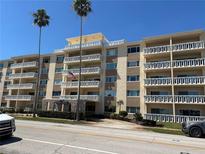 Multi-story condo with multiple balconies, palm trees, and road view with the Shore Crest sign at 1200 N Shore Ne Dr # 212, St Petersburg, FL 33701
