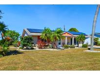 Charming single-story home with solar panels and lush landscaping at 1515 Arrowhead Dr, Sun City Center, FL 33573