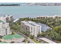 Panoramic aerial view of waterfront condo community, showcasing the building and surrounding natural beauty at 220 Belleview Blvd # 701, Belleair, FL 33756