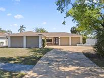 Charming home featuring a well-manicured lawn and a spacious driveway leading to a two-car garage at 4219 Summerdale Dr, Tampa, FL 33624