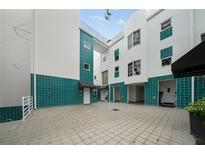 Unique architecture with a teal and white facade plus covered entries and shared courtyard space at 4950 Bayshore Blvd # 14, Tampa, FL 33611
