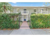 Charming townhouse with a gated entrance and lush green hedges at 5011 S Elberon St, Tampa, FL 33611