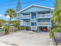 Charming multi-story beach house with spacious balconies, parking, and tropical landscaping at 812 Gulf # 3, Indian Rocks Beach, FL 33785