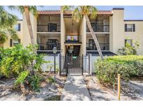 Exterior view of a courtyard in a condo community with mature landscaping at 107 S Obrien St # 117, Tampa, FL 33609