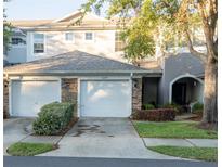 Charming townhome featuring a two-car garage and beautifully maintained landscaping at 19279 Stone Hedge Dr, Tampa, FL 33647