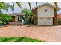 Beautiful home featuring a brick drive and staircase and a two-car garage at 3545 Seaway Dr, New Port Richey, FL 34652