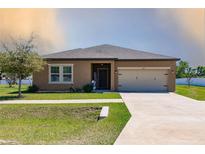 Charming single Gathering home with a well manicured lawn and two car garage at 733 Garden Oaks Sq, Seffner, FL 33584