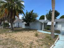 Quaint single story home featuring unique stone accents and mature landscaping at 9741 Scenic Dr, Port Richey, FL 34668