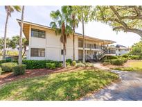 Two-story condo building featuring palm trees and covered staircases at 5020 Mill Pond Rd # 3158 & 3160, Wesley Chapel, FL 33543