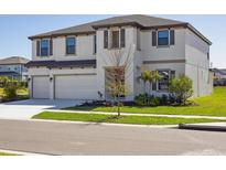 Stunning two-story home featuring a three-car garage and beautiful landscaping at 5335 Wolf Creek Dr, Apollo Beach, FL 33572