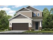 New two-story home featuring a two-car garage, neutral color palette, and professionally landscaped yard at 740 Steel Dr, Apollo Beach, FL 33572