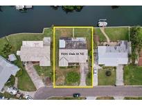 Aerial view of property at 9101 Oak St NE featuring waterfront access and lush landscaping at 9101 Oak Ne St, St Petersburg, FL 33702