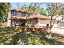 Charming two-story home featuring a well-maintained front yard and attached two-car garage at 1888 Springbush Ln, Clearwater, FL 33763