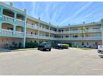 Well-maintained building featuring multiple stories with charming balcony railings and ample parking space at 2331 Finlandia Ln # 43, Clearwater, FL 33763