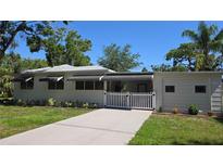 Charming single-story home with a white picket fence and well-manicured landscaping at 2412 53Rd S St, Gulfport, FL 33707