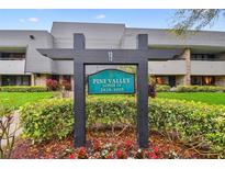 Exterior view of the Pine Valley Lodge 19 sign surrounded by lush landscaping and building at 36750 Us 19 N # 19212, Palm Harbor, FL 34684