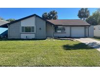 Charming single-story home with a well-manicured lawn, attached garage, and welcoming curb appeal at 3704 Haven Dr, New Port Richey, FL 34652