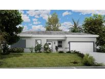 Charming single-story home with a well-manicured lawn and attached two-car garage at 4503 Opel Ter, Port Charlotte, FL 33981