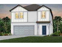 Charming two-story home with white siding, gray trim, a two-car garage, and well-manicured landscaping at 6217 Golden Beach Dr, Apollo Beach, FL 33572