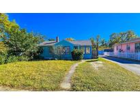Charming blue home featuring a well-maintained lawn and inviting curb appeal on a sunny day at 860 16Th S Ave, St Petersburg, FL 33701