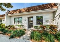Charming home featuring a well-maintained landscaped front yard and a welcoming entrance at 9214 Mission Oaks Blvd, Seminole, FL 33776