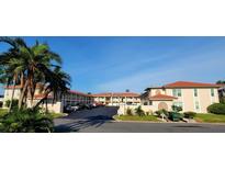 Spacious condos with ample parking, lush tropical landscaping, and beautiful blue skies overhead at 10351 Regal Dr # 18, Largo, FL 33774