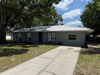 Charming single-story home with metal roof and well-maintained front yard and long driveway at 1417 Murillo Loop, Ruskin, FL 33570