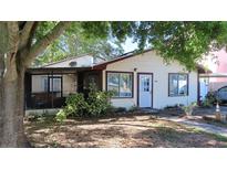 Charming single-story home featuring a screened porch and a cozy front yard at 1436 Ohio Ave, Palm Harbor, FL 34683