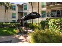Inviting condo building entrance with a covered walkway and lush landscaping at 3325 Bayshore Blvd # D11, Tampa, FL 33629