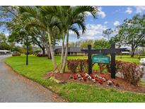 Well maintained community entrance with lush lawn, landscaping, and clear signage at 36750 Us 19 N # 06211, Palm Harbor, FL 34684