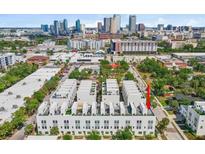 An aerial view showcasing the modern townhome development with a stunning city skyline backdrop at 401 N Oregon Ave # 1, Tampa, FL 33606