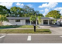 Charming single-story home with a covered carport and well-maintained front yard at 4105 W Iowa Ave, Tampa, FL 33616
