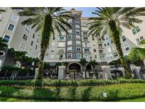 Beautiful condo building featuring mature palm trees and well-maintained landscaping with wrought iron fencing at 700 S Harbour Island Blvd # 404, Tampa, FL 33602