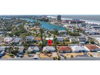 Coastal home with stunning views of the channel and beach, surrounded by lush tropical landscaping at 88 45Th Ave, St Pete Beach, FL 33706