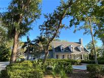 Charming two-story home with a manicured front yard and beautiful mature trees at 8910 Eagle Watch Dr, Riverview, FL 33578