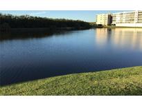 Scenic water view featuring a building reflecting in the calm water on a sunny day at 9860 62Nd N Ter # 1036, St Petersburg, FL 33708
