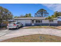 Charming single-story home with a circular driveway and well-maintained front yard at 1988 58Th N St, St Petersburg, FL 33710