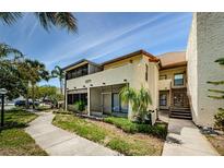 Inviting exterior of the property with a well-maintained yard and pathway to the front at 2571 Cyprus Dr # 1-105, Palm Harbor, FL 34684