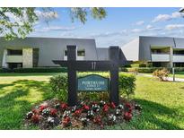 Well-maintained property grounds with sign displaying address in front of condos at 36750 Us 19 N # 17106, Palm Harbor, FL 34684