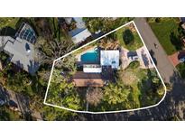Expansive lot featuring a beautiful pool, lush greenery, and distinctive architecture creating an oasis in a desirable neighborhood at 6305 Bahama Shores S Dr, St Petersburg, FL 33705