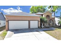 Charming home featuring a two-car garage, fountain, and inviting entryway at 9711 Wydella St, Riverview, FL 33569